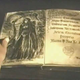 Lidmer reading a passage about MOrgan le Fay from an ancient text.
